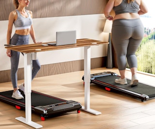 two people on a walking pad in a room