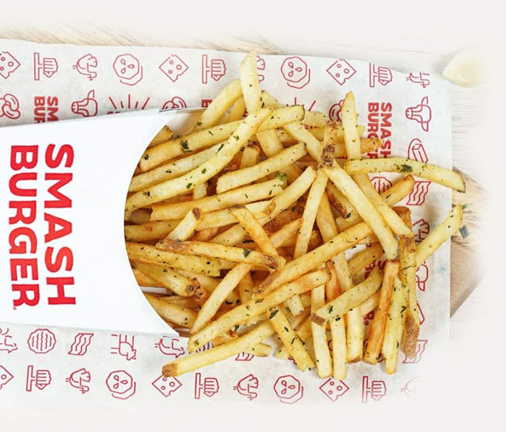 smash burger fries spilling out of box on table 