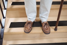 Grip tape on floor, a pair of feet with a cane