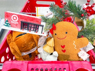 Target LED store front, turkey slippers, gingerbread plush, pine garland, and other trinket in a Target cart