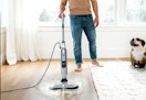 person using the Shark Steam & Scrub mop on a wooden floor