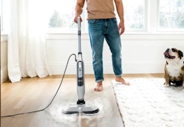 person using the Shark Steam & Scrub mop on a wooden floor
