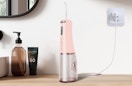 a pink water flosser on a table 