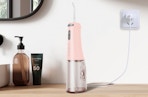 a pink water flosser on a table 
