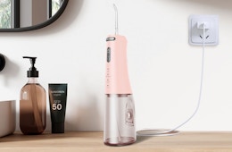 a pink water flosser on a table 
