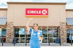 a nurse outside of Circle K with a drink