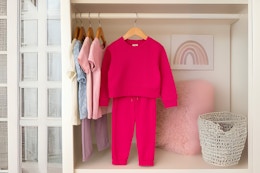 AI image created by Chat GPT of the Athletic Works Sweat Set in pink hanging in closet