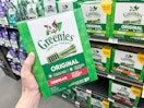 greenies dog treats being held in hand