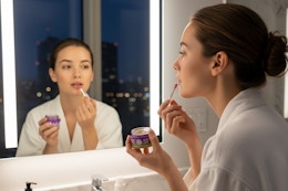 a woman using a lip mask on her lips