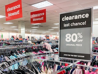 An 80% off Clearance sign affixed to a clothing rack at Belk.