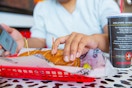 Person grabbing a sandwich