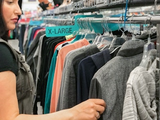Someone looking through clothes on a rack at Plato's Closet