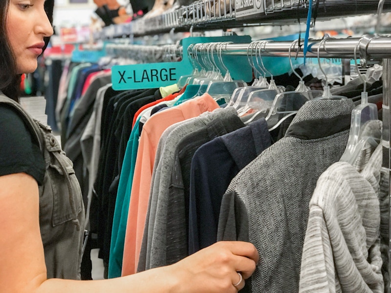 Someone looking through clothes on a rack at Plato's Closet