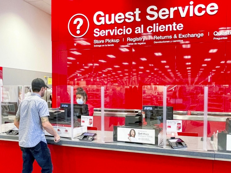 A person talking to an employee at the Target guest service counter.