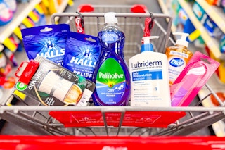 air wick warmer, halls cough drops, palmolive dish soap, lubriderm lotion, dial hand soap, and a nail buffer in a cart