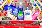 air wick warmer, halls cough drops, palmolive dish soap, lubriderm lotion, dial hand soap, and a nail buffer in a cart
