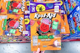 hand holding a box of kool aid ghoul aid drinks