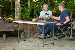 couple sitting outside drinking wine at table