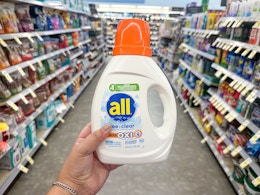 hand holding all free and clear laundry detergent in walgreens