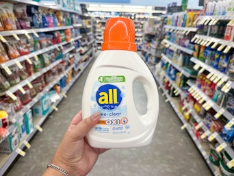 hand holding all free and clear laundry detergent in walgreens