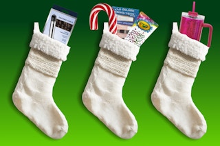white stockings filled with items on a green background