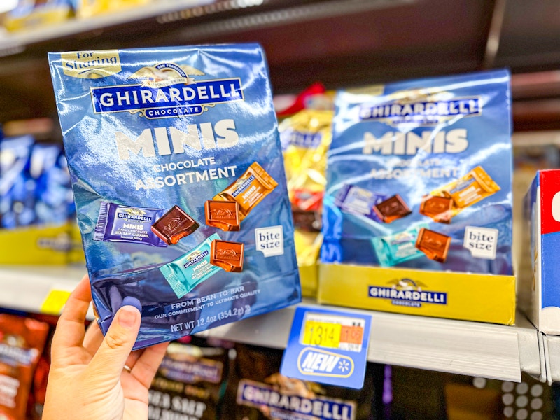 hand holding a bag of ghirardelli minis at walmart