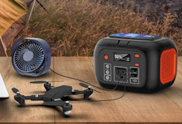 a power station charging a drone and fan on a patio