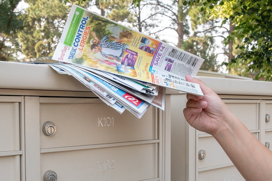 someone grabbing paper from top of mailbox