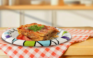 food on a paper plate on a wooden table