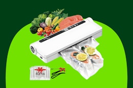 A white vacuum sealer machine has raw veggies and meat going in and fish with lemons coming out. 40 bags are included.