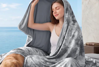 a person laying under a cooling blanket