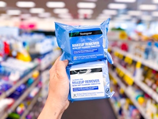 hand holding two neutrogena makeup wipe packs