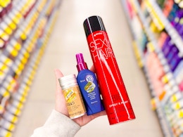 hand holding tigi, it's a 10, and sexy hair products in walgreens