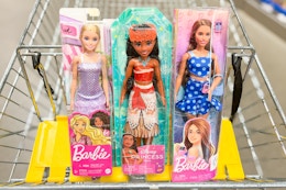 barbie dolls in a shopping cart