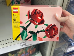 hand grabbing a lego roses set off a target shelf