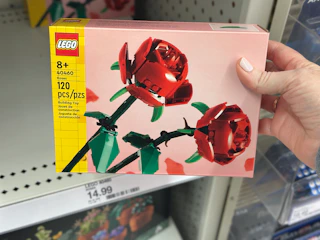 hand grabbing a lego roses building kit off a target shelf