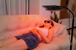 a woman using a red light device