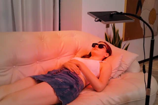 a woman using a red light device