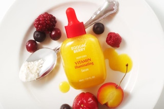 Vitamin serum bottle on plate