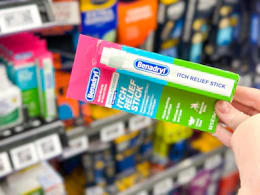 hand holding benadryl stick in walmart aisle