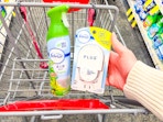 person placing a febreze plug warmer in a cart by air freshener