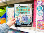 hand grabbing a disney stick jewelry design kit off a target shelf