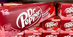 Someone taking a box of the new Dr Pepper Strawberries and Cream flavored soda from a shelf