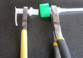 Pliers pulling the pump out of a lotion pump top.