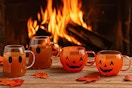 Lifestyle image of the Way to Celebrate Halloween Glass Mugs (Ghost & Pumpkin) AI image created by ChatGPT with fire in the background