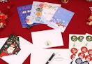 Christmas cards and stationery on a red table 