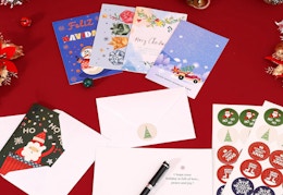 Christmas cards and stationery on a red table 