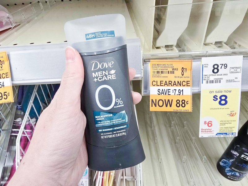 person holding a dove mens deodorant by a $0.88 clearance sign