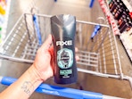 hand holding a bottle of Axe body wash
