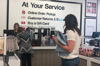 Woman standing in line at the Macy's return counter.